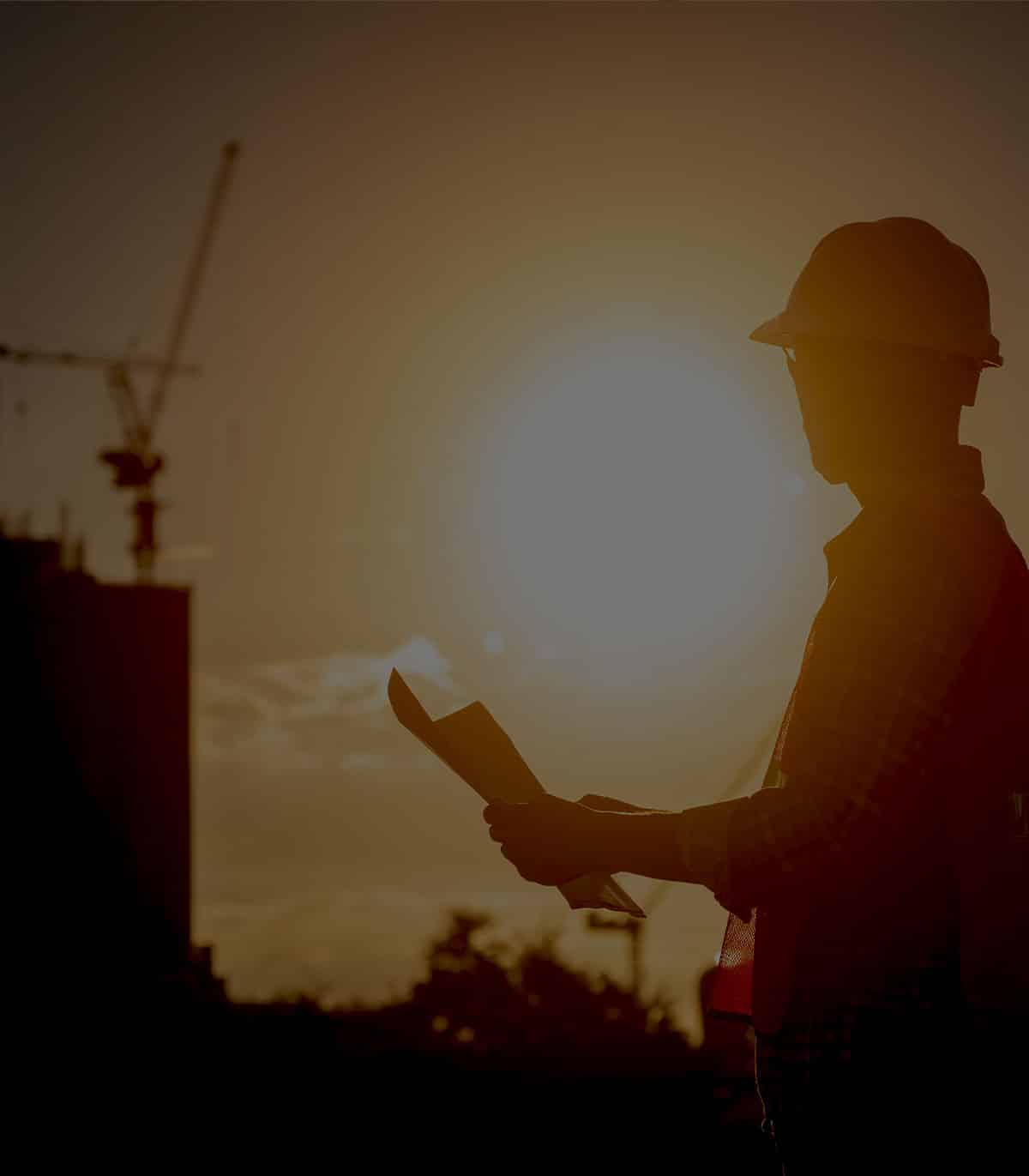 a man standing in front of a sunset